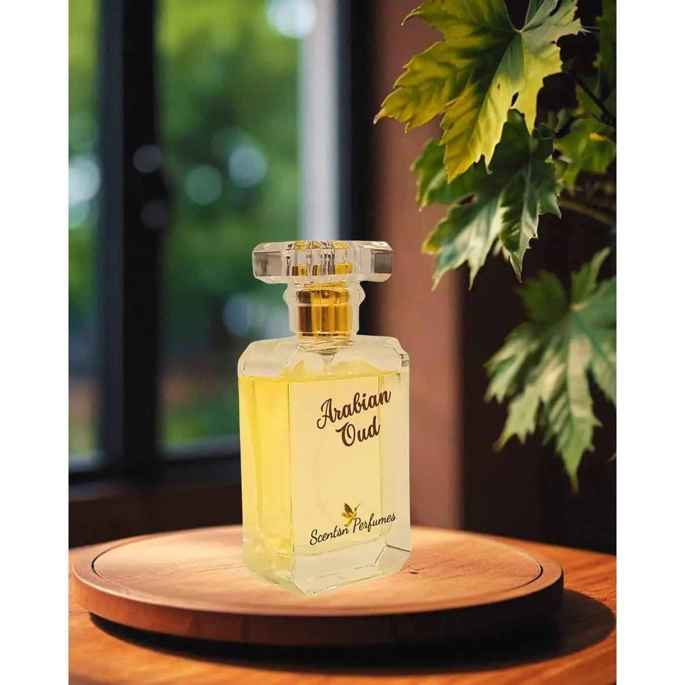 Arabian Oud perfume bottle from ScentsnPerfumes with intricate gold design and clear glass showcasing the fragrance inside.